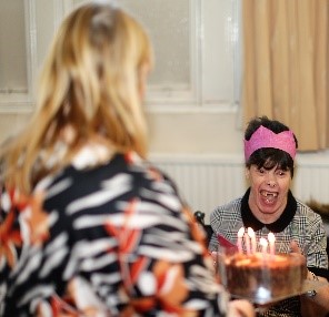 person celebrating their birthday by having birthday cake