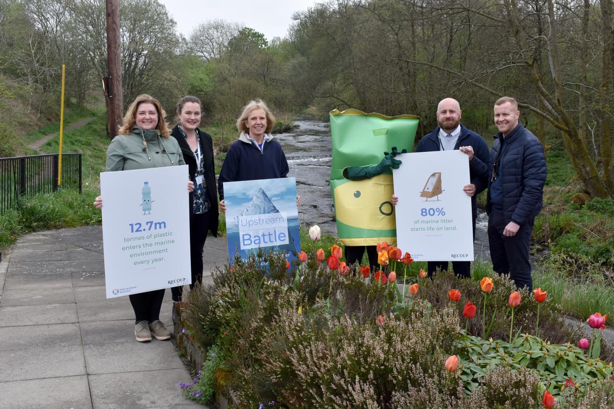 Image of Cllr Muurray and people holding placards for the waterways clean up.
