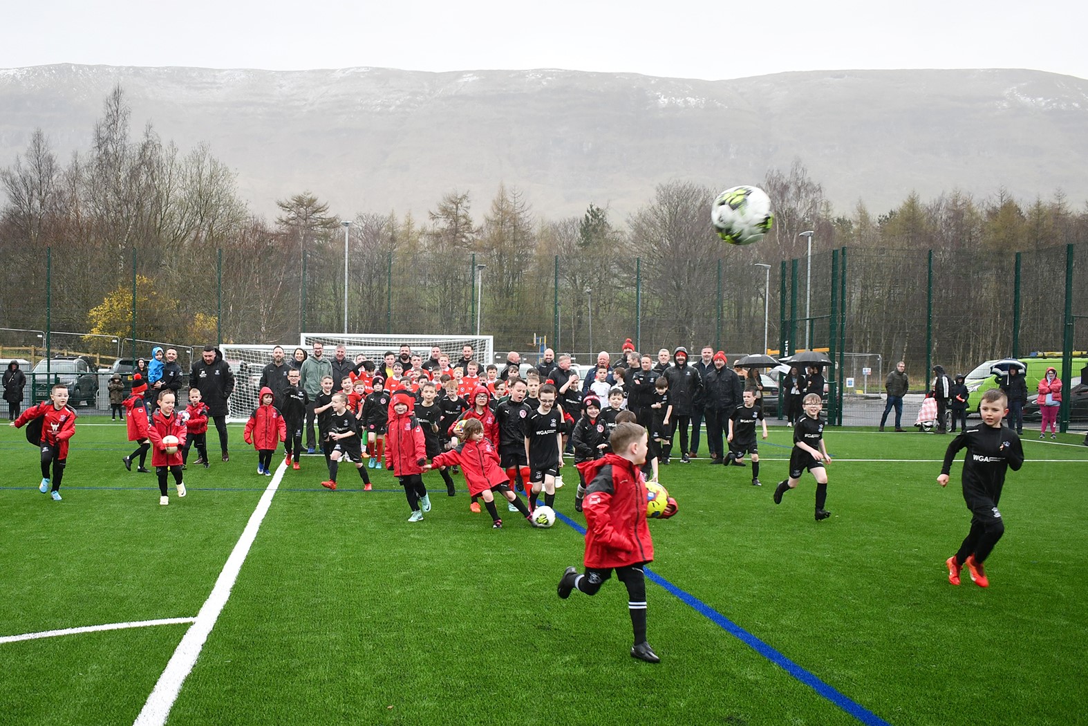 Kids playing football on the ew pitch at Lennoxtown