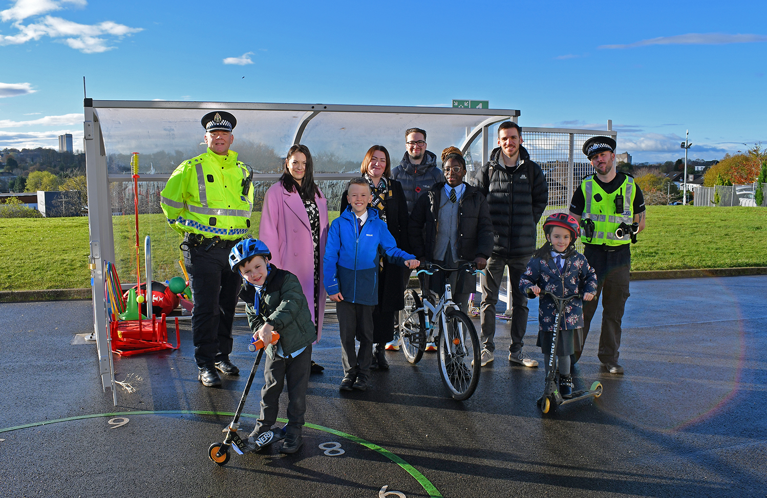 Councilllor Paul Ferretti, Convener of the PNCA committee is flanked by the Headteachers of St Matthew’s Primary School and Wester Cleddens Primary School. Also in pictured are two members of the Community Police team and two pupils from each school posing with scooters and bicycles.