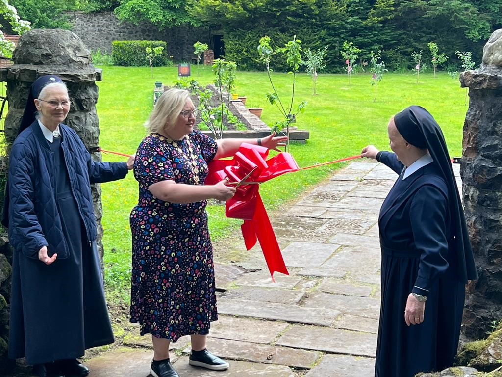 Provost Renwick and others at Schoenstatt Garden cutting the ribbon