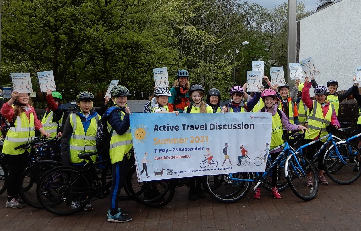 group holding up active travel banner
