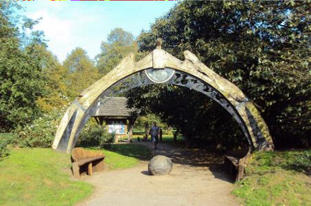 person walking under a metal arch structure at mugdock