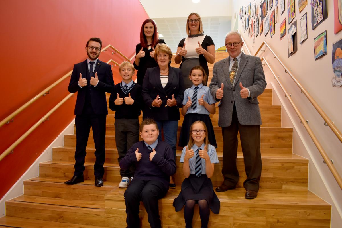 Teachers, pupils and councillors on staircase