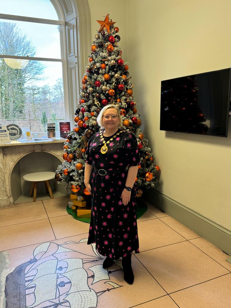 Provost in front of Christmas tree