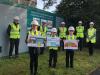 workers and children holding signs for new allander design