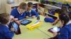 children at desk with ipads